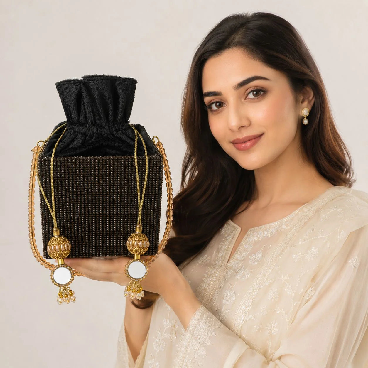 black rihnestone ptel clutch with pearl handle and gold tussle